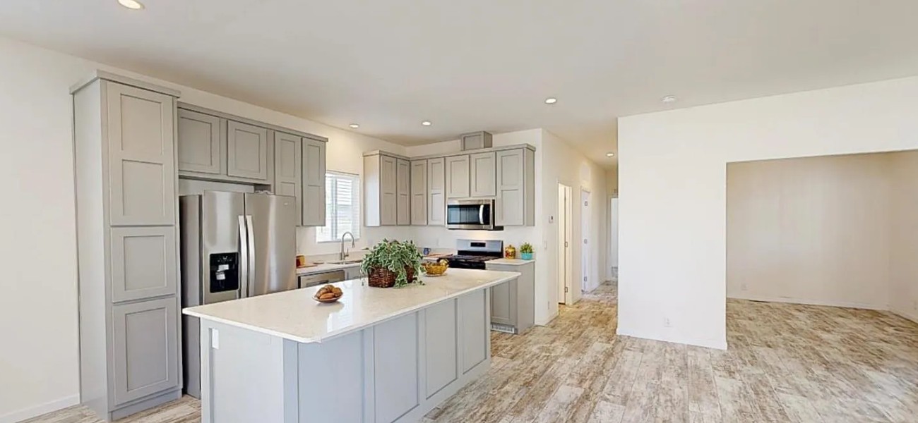 Bright kitchen with a large island in a previous Bueno Mobile Homes listing